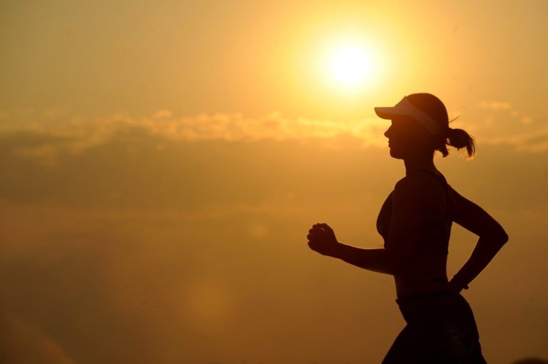 silhouette of woman running in the sunset