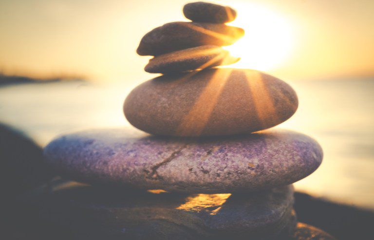 balanced rocks by the sea on a sunset