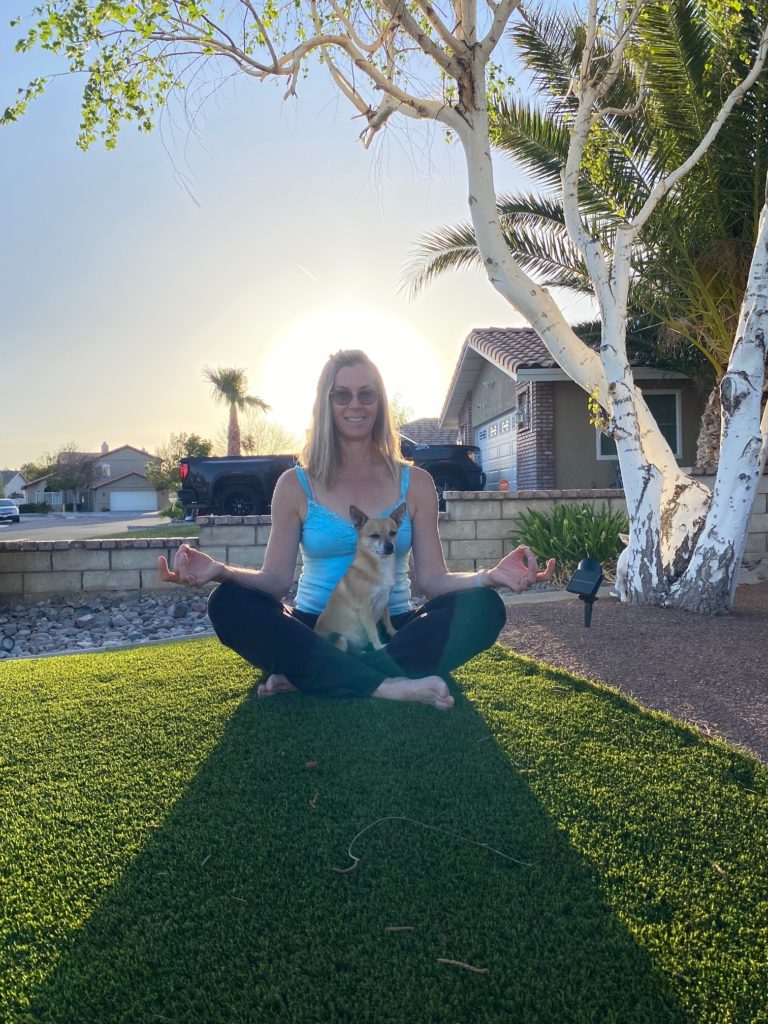 Woman with good posture sitting in grass. I align my posture to make daily activities easier for my body