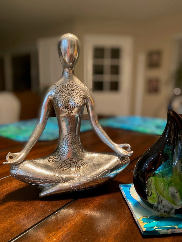 Statue of Female in Meditation   position: symbol for the breath and the flowers of change and chakra clearing.